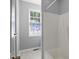 Bathroom featuring a tub/shower combination and a vibrant patterned window with blinds at 106 Gumdrop Path, Apex, NC 27502