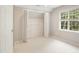 Bedroom features a large window, closet with folding doors, and neutral carpet at 106 Gumdrop Path, Apex, NC 27502
