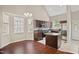 Eat-in kitchen with stainless appliances, granite counters, kitchen island, and vaulted ceilings at 106 Gumdrop Path, Apex, NC 27502