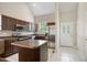 Updated kitchen with stainless appliances, granite countertops, and kitchen island with breakfast bar at 106 Gumdrop Path, Apex, NC 27502