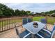 Outdoor back deck with patio dining set and a beautiful backyard view at 1100 Open Field Dr, Garner, NC 27529