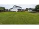 Expansive backyard with a privacy fence, mature trees, and a large grassy area at 1100 Open Field Dr, Garner, NC 27529