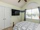 Bedroom with vaulted ceilings, TV and closet space by a sunny window at 1100 Open Field Dr, Garner, NC 27529