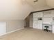 Bright bonus room offering built in shelving and a comfortable seating area at 1100 Open Field Dr, Garner, NC 27529