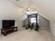 Finished bonus room features a gym set and entertainment area with television at 1100 Open Field Dr, Garner, NC 27529