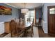 Charming dining room with a sunflower painting, elegant lighting and window at 1100 Open Field Dr, Garner, NC 27529