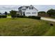 Traditional home with a well-maintained lawn, mature landscaping, and a two-car garage at 1100 Open Field Dr, Garner, NC 27529