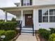 Charming home exterior featuring a covered front porch and well-manicured landscaping at 1100 Open Field Dr, Garner, NC 27529