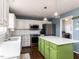 This bright kitchen offers stainless steel appliances, white cabinets and a green island at 1100 Open Field Dr, Garner, NC 27529