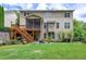 Back of home showing deck, screened in porch and swing set over large backyard at 112 Briarfield Dr, Apex, NC 27502