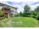 Back of home showing deck, screened in porch and swing set over large backyard at 112 Briarfield Dr, Apex, NC 27502