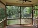 Screened back porch offering a serene view of the lush, wooded backyard at 112 Briarfield Dr, Apex, NC 27502