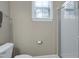 Well lit bathroom featuring a shower, toilet, and a window for ventilation, designed for convenience at 112 Briarfield Dr, Apex, NC 27502