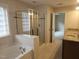 Bright bathroom with dual vanity, granite countertops, a separate glass shower, and a luxurious soaking tub at 112 Briarfield Dr, Apex, NC 27502