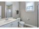 Functional bathroom featuring a shower, toilet, vanity with sink, and a window for ventilation at 112 Briarfield Dr, Apex, NC 27502