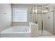 Bright bathroom featuring glass enclosed shower and soaking tub at 112 Briarfield Dr, Apex, NC 27502