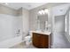 Bathroom showcasing a tub with shower, vanity and great lighting at 112 Briarfield Dr, Apex, NC 27502