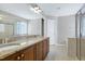 Bright bathroom featuring double sink vanity and glass enclosed shower at 112 Briarfield Dr, Apex, NC 27502