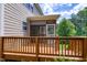 Wooden deck with screened-in portion, perfect for outdoor relaxation and entertaining with view of the backyard at 112 Briarfield Dr, Apex, NC 27502