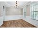 Bright formal dining room with wainscoting, chandelier lighting, and large windows at 112 Briarfield Dr, Apex, NC 27502