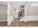 Bright foyer with hardwood floors, wainscoting, staircase and open access to other rooms at 112 Briarfield Dr, Apex, NC 27502