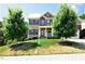 Charming two-story home with a well-manicured lawn, mature trees and a welcoming front porch at 112 Briarfield Dr, Apex, NC 27502