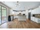 Modern kitchen with stainless steel appliances, white cabinets, a center island, and wood floors at 112 Briarfield Dr, Apex, NC 27502