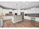 Spacious open kitchen with stainless steel appliances, bar seating, and ample counter space for cooking at 112 Briarfield Dr, Apex, NC 27502