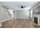 Bright living room with fireplace, staircase, and neutral paint, creating an inviting and comfortable space at 112 Briarfield Dr, Apex, NC 27502