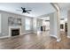 Open-concept living room with wood floors, a fireplace, recessed lights, and views into kitchen at 112 Briarfield Dr, Apex, NC 27502