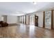 Spacious living room featuring hardwood floors, sofa, and lots of windows at 112 Briarfield Dr, Apex, NC 27502