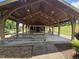 Community pavilion with wood beams and picnic tables on a sunny day, perfect for outdoor gatherings at 112 Briarfield Dr, Apex, NC 27502