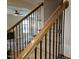 View of staircase with wooden handrail, iron spindles, and carpeted steps, leading to an upstairs living space at 112 Briarfield Dr, Apex, NC 27502
