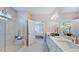 Modern bathroom with a glass shower, double sink vanity, and neutral color palette with an open view into the bedroom at 1124 Sun Springs Rd, Wake Forest, NC 27587