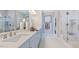 Bright bathroom with double sink vanity, quartz countertop, glass shower, and tiled floors at 1124 Sun Springs Rd, Wake Forest, NC 27587