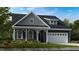 Charming craftsman-style home featuring a well-manicured lawn and an attached two-car garage at 1124 Sun Springs Rd, Wake Forest, NC 27587