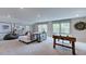 Recreation room with an air hockey table, couch, and lots of natural light, perfect for entertaining guests at 1124 Sun Springs Rd, Wake Forest, NC 27587
