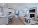 Open-concept living room and kitchen area featuring hardwood floors and modern design at 1124 Sun Springs Rd, Wake Forest, NC 27587