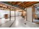Spacious unfinished basement with white walls, tiled floor, and a staircase at 1219 Lakeland St, Durham, NC 27701