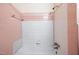 Vintage bathroom featuring pink tiling with a shower and bathtub combination at 1219 Lakeland St, Durham, NC 27701