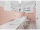 Retro bathroom with double sinks, tiled walls, and vanity mirror at 1219 Lakeland St, Durham, NC 27701