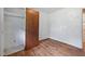 Modest bedroom with a wooden closet door, neutral walls, and access to an adjacent bathroom at 1219 Lakeland St, Durham, NC 27701