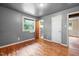 Bedroom featuring hardwood floors, natural light, and a view to an additional room at 1219 Lakeland St, Durham, NC 27701