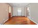 Sunlit dining room featuring hardwood floors, vintage chandelier and access to the kitchen and living room at 1219 Lakeland St, Durham, NC 27701