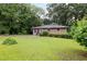 Quaint brick home with a well-manicured lawn and mature landscaping at 1219 Lakeland St, Durham, NC 27701
