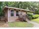 Close-up of brick home showcasing a cozy front porch and shuttered windows at 1219 Lakeland St, Durham, NC 27701
