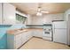 Functional kitchen with white cabinetry, standard appliances, and light countertops at 1219 Lakeland St, Durham, NC 27701