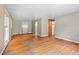 Open living room boasts hardwood floors, neutral walls, and natural light, with an adjacent dining area at 1219 Lakeland St, Durham, NC 27701