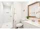 Modern bathroom featuring a glass-enclosed shower, and a decorative mirror above the vanity at 1246 Nc-27, Benson, NC 27504