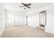 Bright bedroom with a ceiling fan and neutral carpet flooring; doors for easy access at 1246 Nc-27, Benson, NC 27504